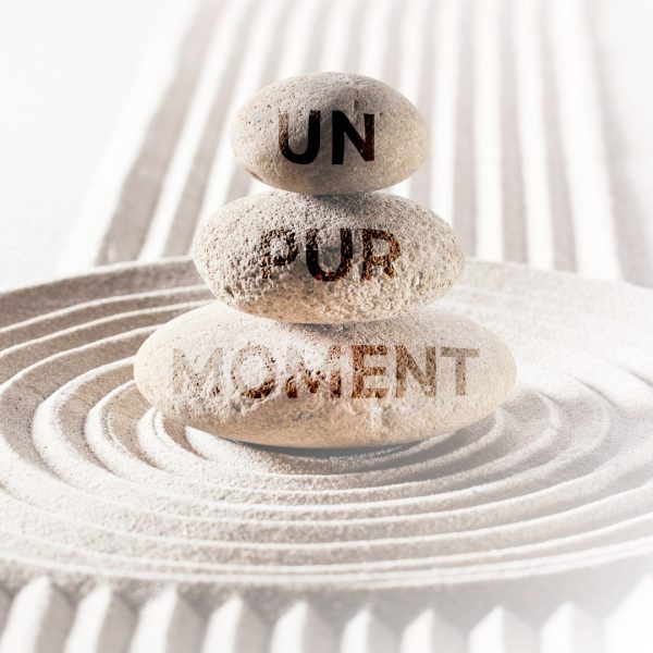 Pierres empilées avec l’inscription “Un pur Moment”, symbolisant l’offre bien-être de l’Institut Naxane à La Grand-Croix, incluant spa, hammam, et soins relaxants.